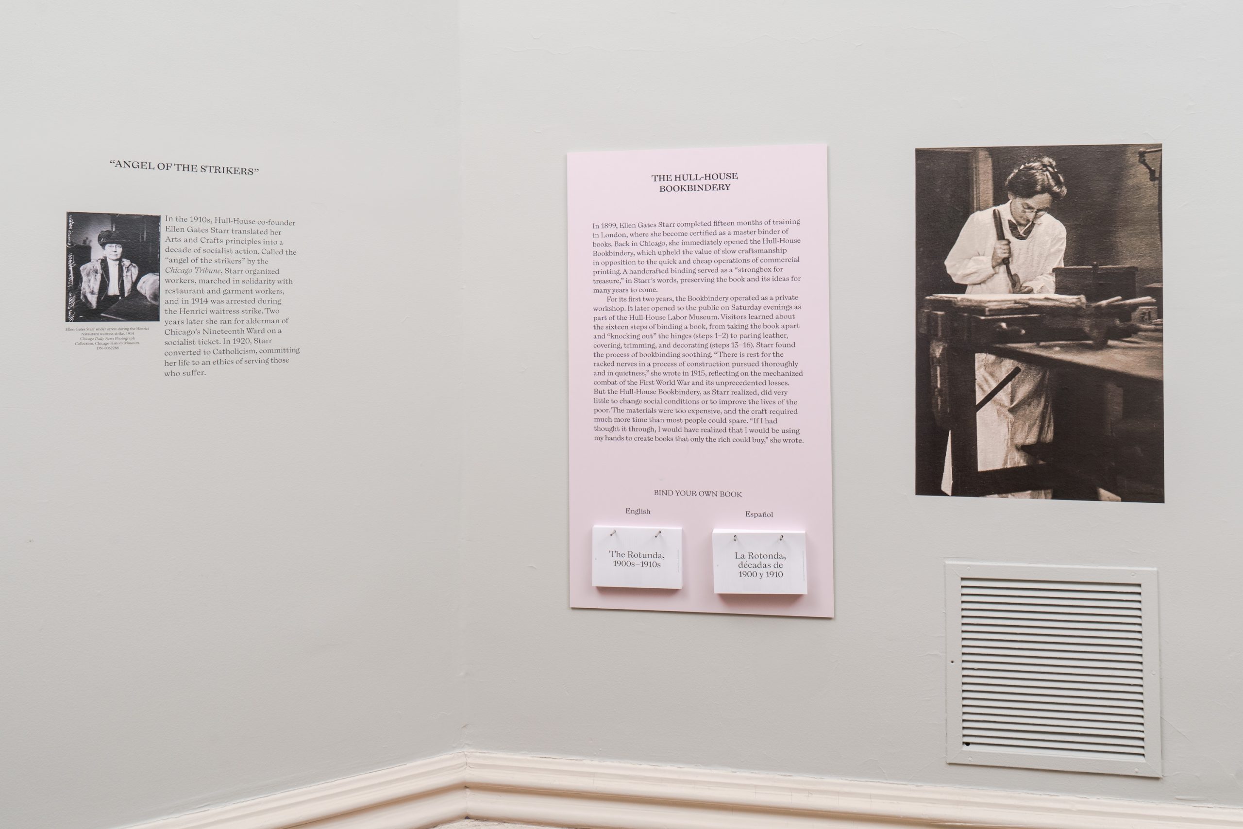 Exhibit wall with three panels: one with a portrait and text titled Angel of the Switches, a central panel with text titled The Hell-Archer Experiment, and a large black-and-white photo of a woman working at a desk.