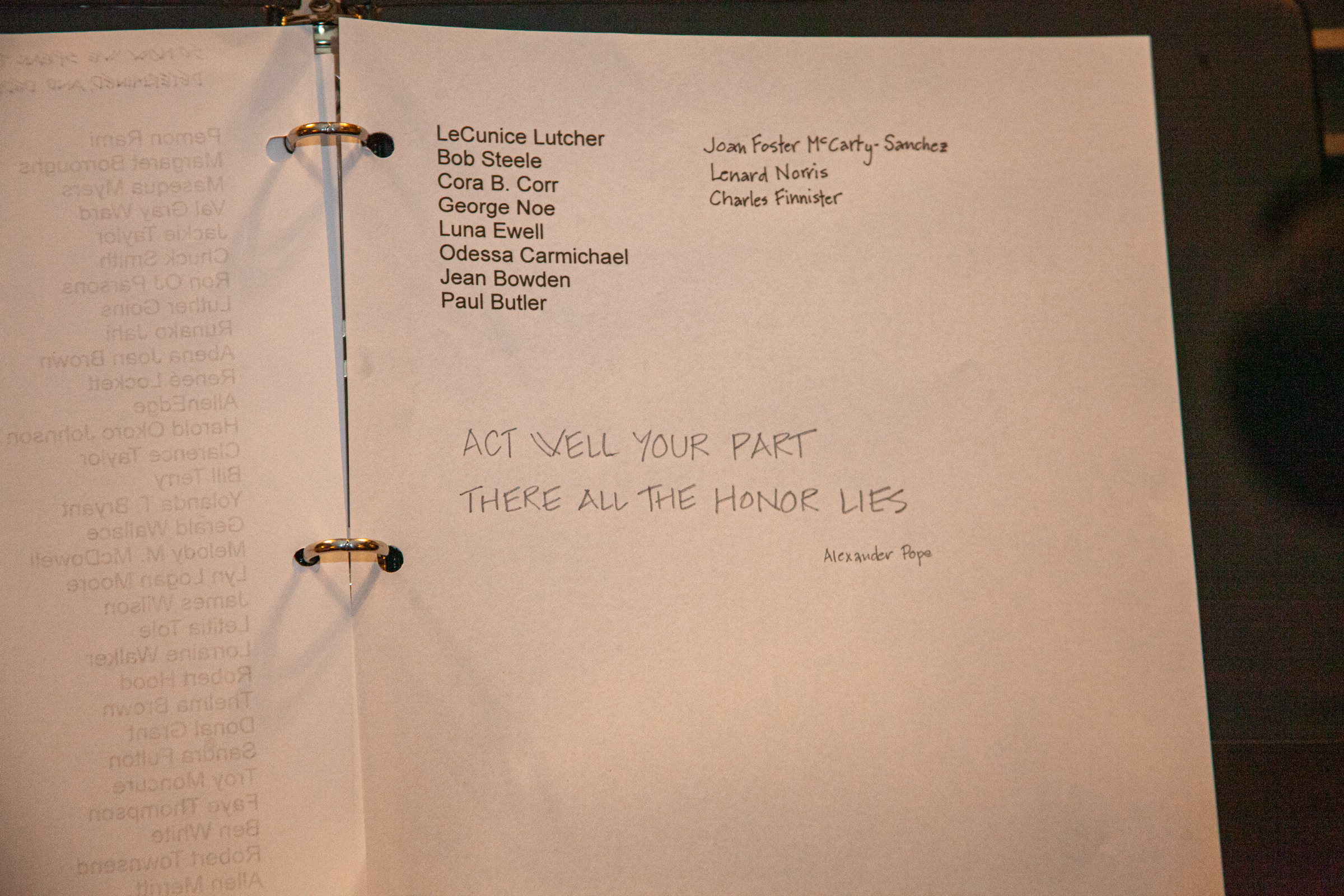 A binder with a typed cast list on the left and a white page on the right, displaying handwritten text: ACT WELL YOUR PART THERE ALL THE HONOR LIES attributed to Alexander Pope.
