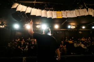 Man on stage facing audience