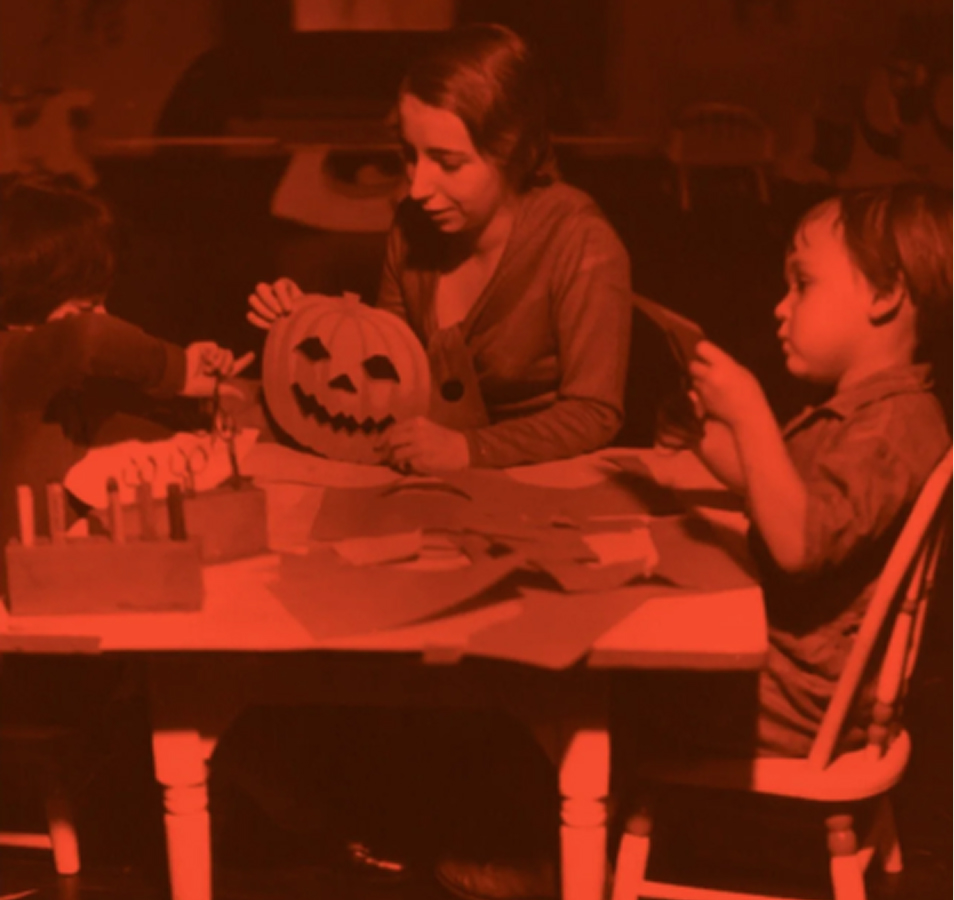 Two children and an adult making halloween crafts