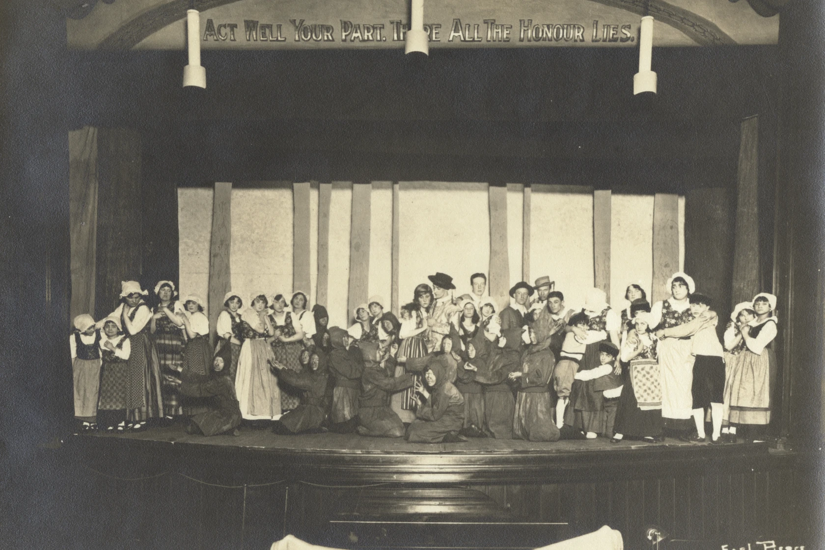 Dozens of people on stage in costume